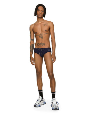 SWIM BRIEFS WITH HIGH-CUT LEG AND BRANDED PLATE