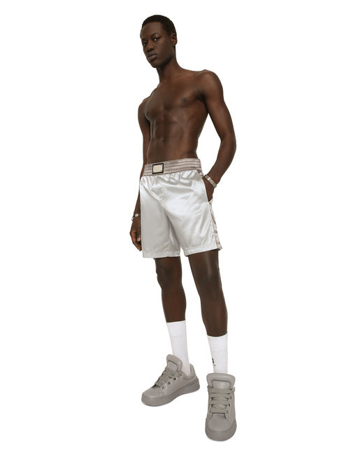 MID-LENGTH SWIM TRUNKS WITH BANDS AND LOGO TAG