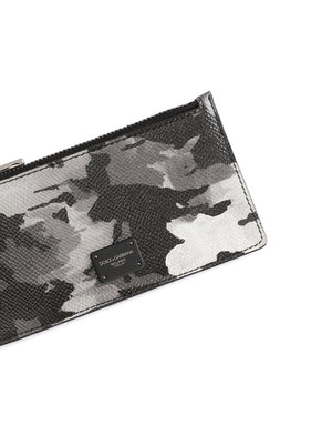 DAUPHINE CALFSKIN CARD HOLDER WITH LEOPARD PRINT AGAINST A GRAY BACKGROUND