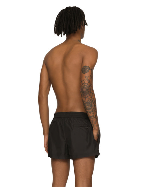SHORT SWIM TRUNKS WITH BRANDED PLATE