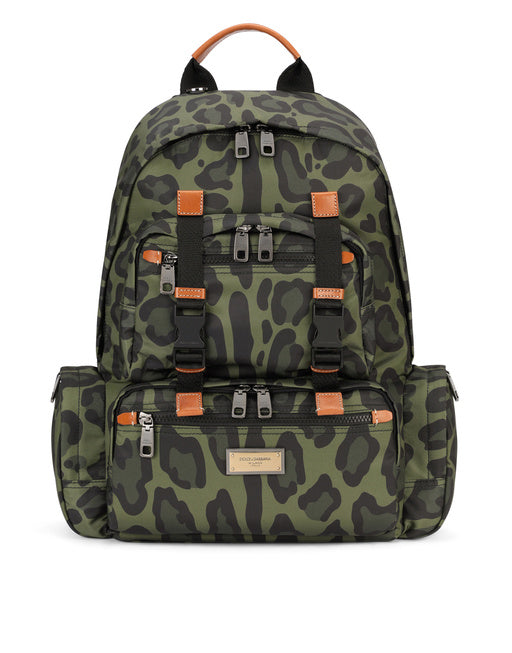 NYLON BACKPACK WITH LEOPARD PRINT AGAINST A GREEN BACKGROUND AND BRANDED PLATE