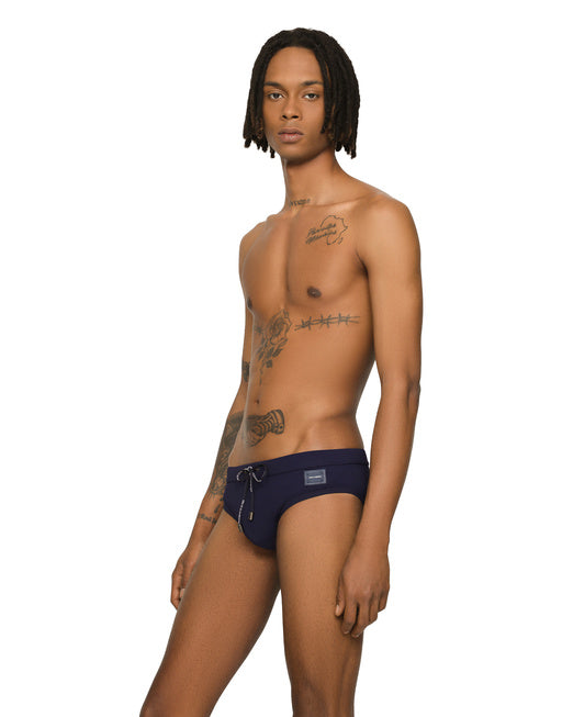SWIM BRIEFS WITH HIGH-CUT LEG AND BRANDED PLATE