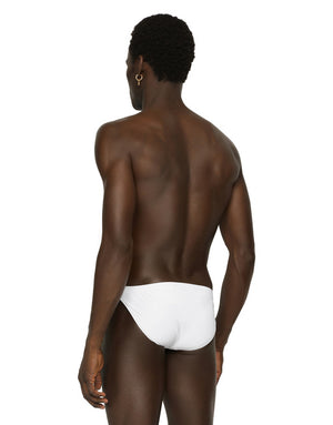 SWIM BRIEFS WITH LOGO PLATE AND COIN CHARM