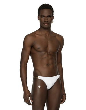SWIM BRIEFS WITH LOGO PLATE AND COIN CHARM