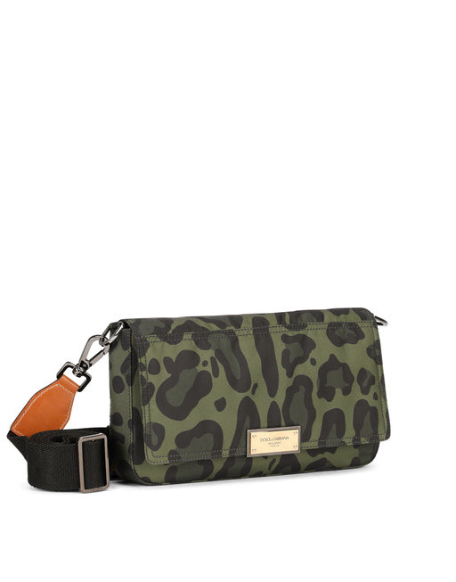 NYLON CROSSBODY BAG WITH LEOPARD PRINT AGAINST A GREEN BACKGROUND AND BRANDED PLATE