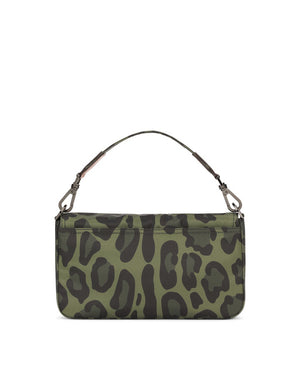 NYLON CROSSBODY BAG WITH LEOPARD PRINT AGAINST A GREEN BACKGROUND AND BRANDED PLATE