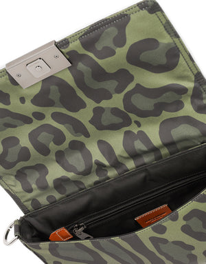 NYLON CROSSBODY BAG WITH LEOPARD PRINT AGAINST A GREEN BACKGROUND AND BRANDED PLATE