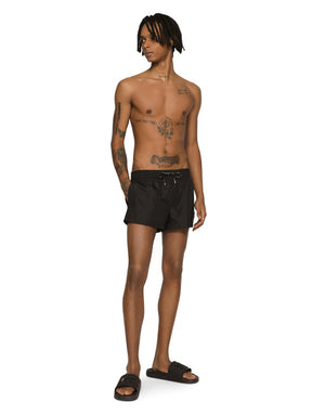 SHORT SWIM TRUNKS WITH BRANDED PLATE