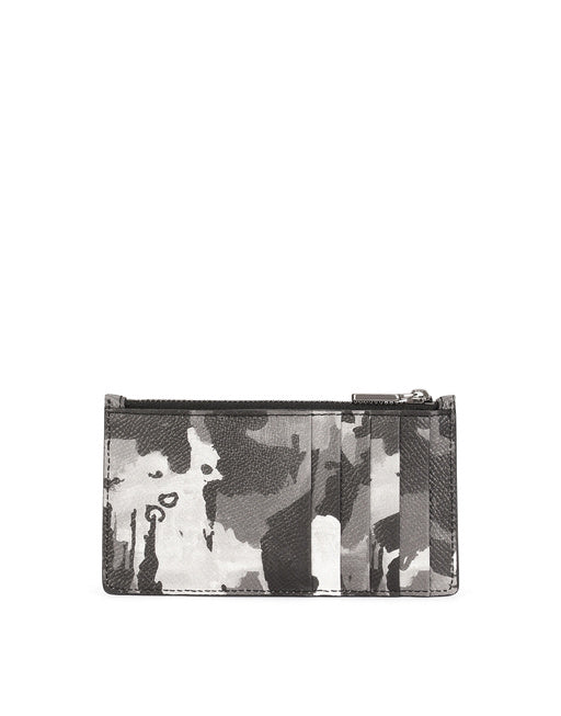 DAUPHINE CALFSKIN CARD HOLDER WITH LEOPARD PRINT AGAINST A GRAY BACKGROUND