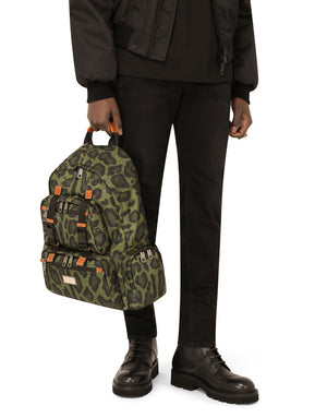 NYLON BACKPACK WITH LEOPARD PRINT AGAINST A GREEN BACKGROUND AND BRANDED PLATE