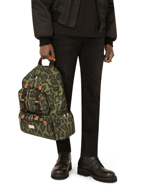 NYLON BACKPACK WITH LEOPARD PRINT AGAINST A GREEN BACKGROUND AND BRANDED PLATE