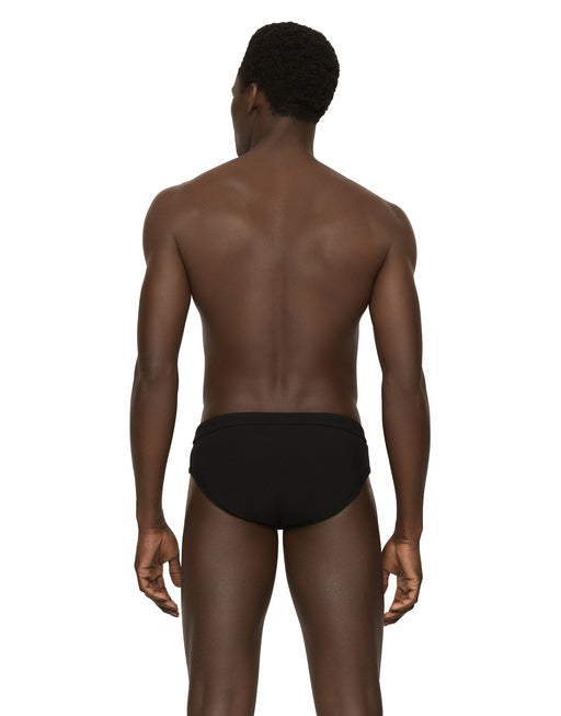 SWIM BRIEFS WITH HIGH-CUT LEG AND BRANDED PLATE
