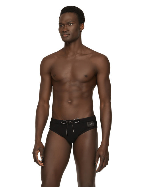 SWIM BRIEFS WITH HIGH-CUT LEG AND BRANDED PLATE