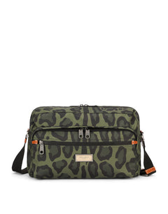 NYLON MESSENGER BAG WITH A LEOPARD PRINT AGAINST A GREEN BACKGROUND AND BRANDED PLATE