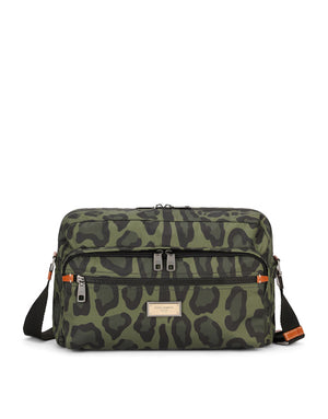 NYLON MESSENGER BAG WITH A LEOPARD PRINT AGAINST A GREEN BACKGROUND AND BRANDED PLATE