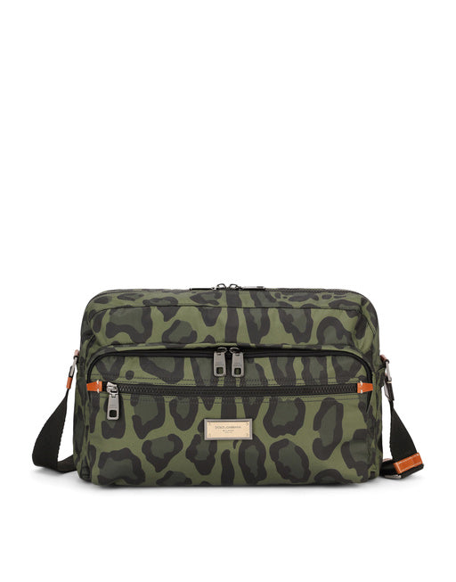 NYLON MESSENGER BAG WITH A LEOPARD PRINT AGAINST A GREEN BACKGROUND AND BRANDED PLATE