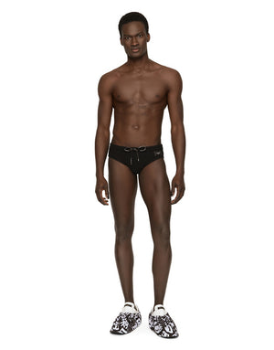 SWIM BRIEFS WITH HIGH-CUT LEG AND BRANDED PLATE