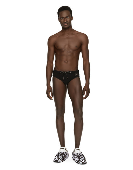 SWIM BRIEFS WITH HIGH-CUT LEG AND BRANDED PLATE
