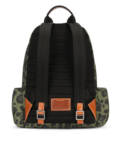 NYLON BACKPACK WITH LEOPARD PRINT AGAINST A GREEN BACKGROUND AND BRANDED PLATE