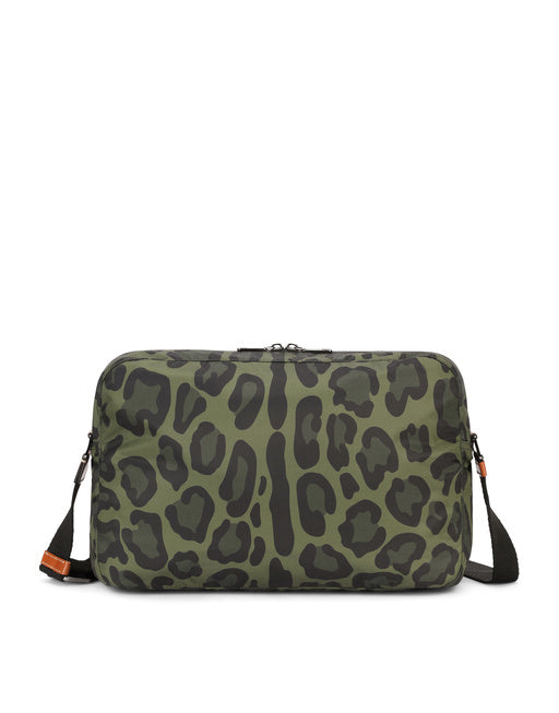 NYLON MESSENGER BAG WITH A LEOPARD PRINT AGAINST A GREEN BACKGROUND AND BRANDED PLATE