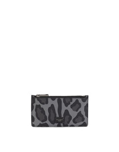 DAUPHINE CALFSKIN CARD HOLDER WITH LEOPARD PRINT AGAINST A GRAY BACKGROUND