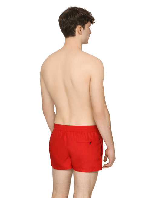 SHORT SWIM TRUNKS WITH BRANDED PLATE