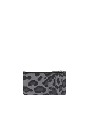 DAUPHINE CALFSKIN CARD HOLDER WITH LEOPARD PRINT AGAINST A GRAY BACKGROUND