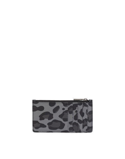 DAUPHINE CALFSKIN CARD HOLDER WITH LEOPARD PRINT AGAINST A GRAY BACKGROUND