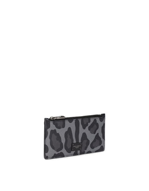 DAUPHINE CALFSKIN CARD HOLDER WITH LEOPARD PRINT AGAINST A GRAY BACKGROUND