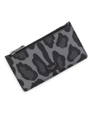 DAUPHINE CALFSKIN CARD HOLDER WITH LEOPARD PRINT AGAINST A GRAY BACKGROUND
