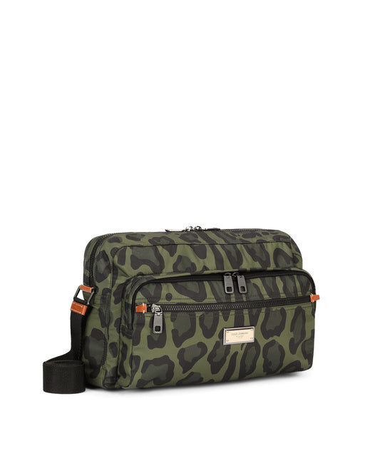 NYLON MESSENGER BAG WITH A LEOPARD PRINT AGAINST A GREEN BACKGROUND AND BRANDED PLATE